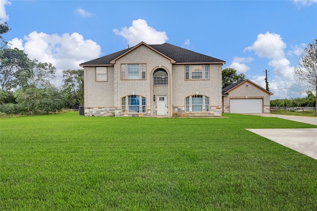 view of front of property with a garage and a front lawn