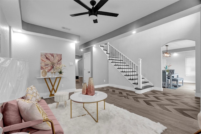 living room featuring parquet flooring and ceiling fan