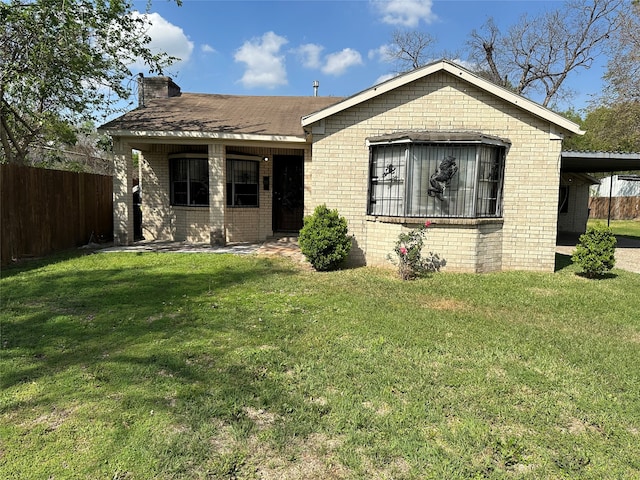 rear view of property with a lawn