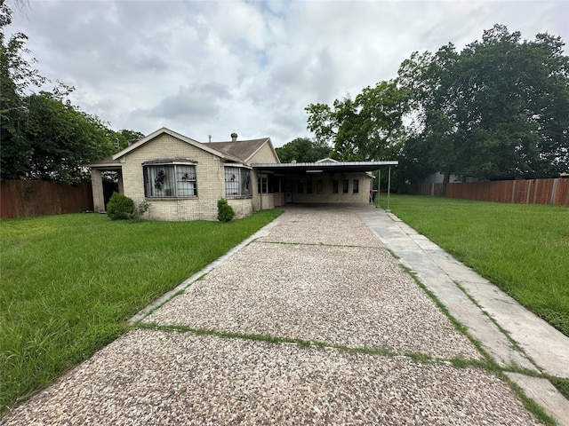 ranch-style home with a carport and a front yard