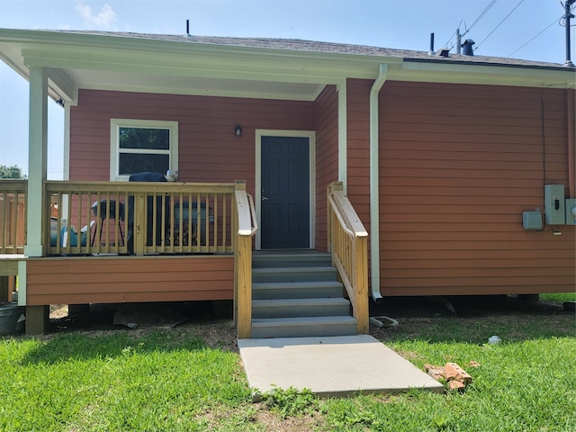 doorway to property with a yard