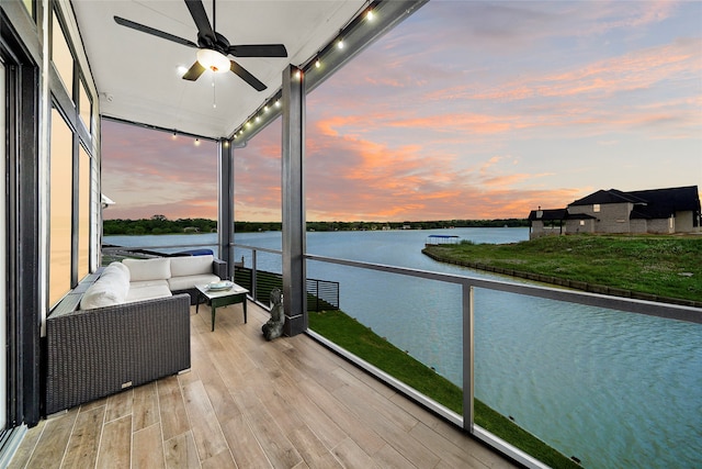 exterior space with a water view, ceiling fan, and outdoor lounge area