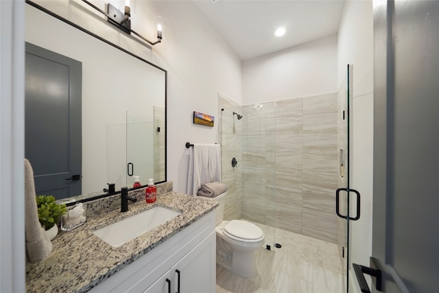 full bathroom featuring vanity, a shower stall, and toilet