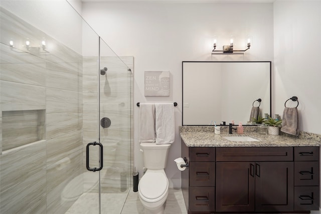 full bathroom with toilet, a shower stall, and vanity