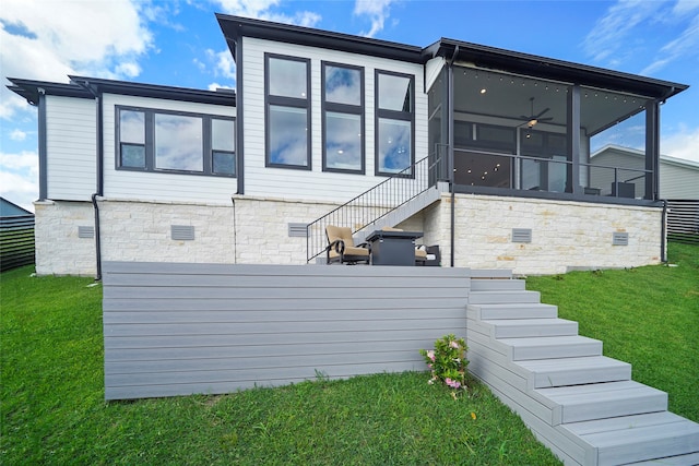 rear view of property with crawl space, a sunroom, stairs, and a yard