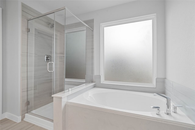 bathroom with wood-type flooring and plus walk in shower