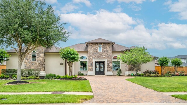 view of front of house featuring a front yard and french doors