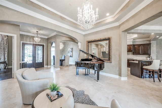 entryway featuring french doors, ornamental molding, and a notable chandelier