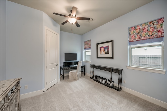 home office with light carpet and ceiling fan