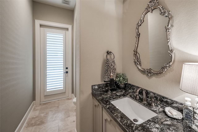 bathroom featuring vanity and toilet