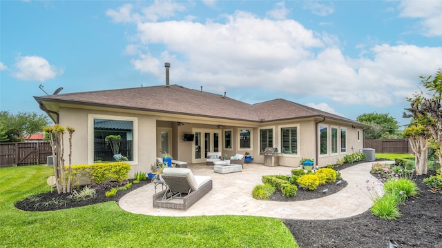 rear view of property featuring a lawn, ceiling fan, a patio, and central AC unit