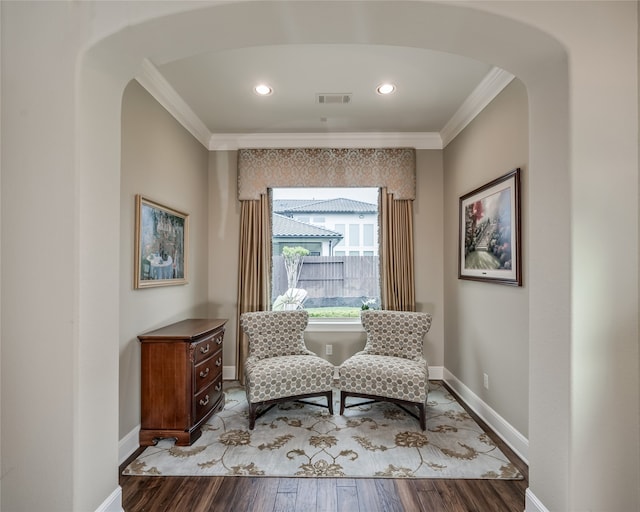 sitting room featuring wood-type flooring and crown molding