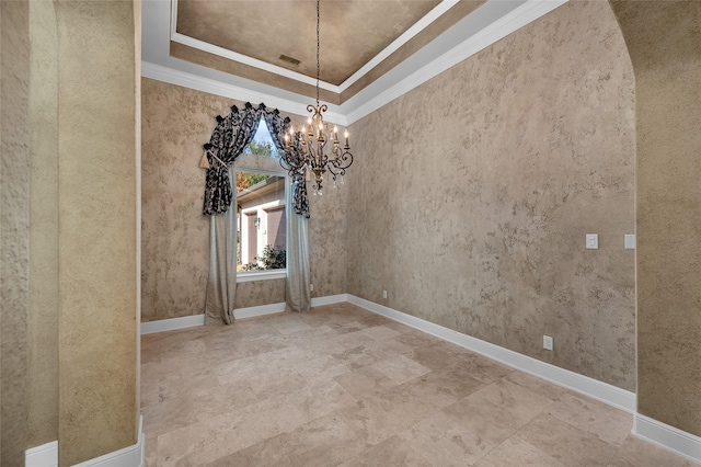 unfurnished room featuring a raised ceiling, crown molding, and a chandelier