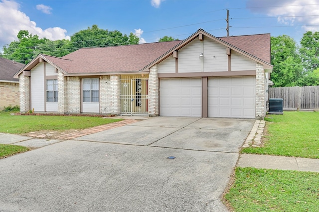 single story home featuring a garage, central AC, and a front lawn