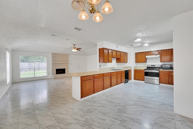 kitchen with light tile flooring, a fireplace, kitchen peninsula, appliances with stainless steel finishes, and sink