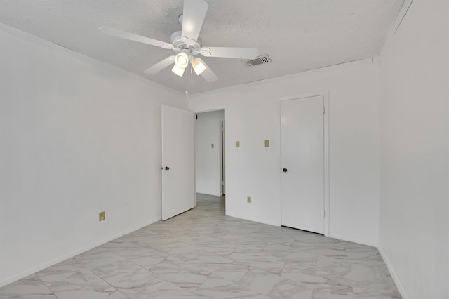 unfurnished bedroom with a textured ceiling, ceiling fan, and light tile floors