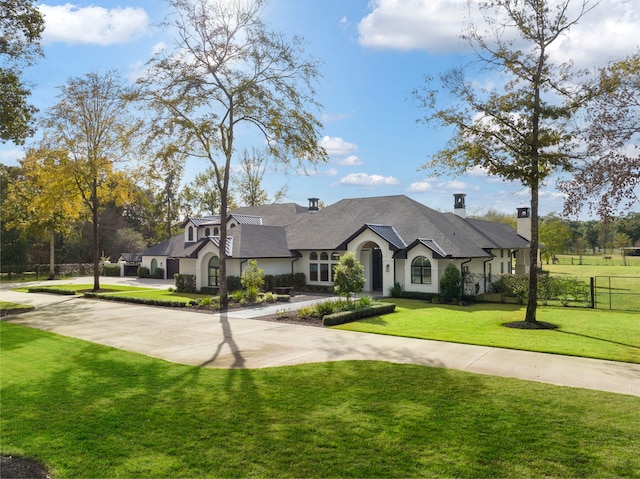 french country home featuring a front yard