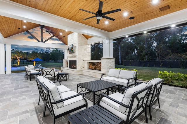 view of patio featuring an outdoor living space with a fireplace and ceiling fan