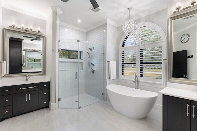 bathroom with ornamental molding, ceiling fan with notable chandelier, tile floors, and vanity with extensive cabinet space