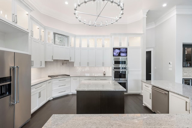 kitchen featuring light stone countertops, dark hardwood / wood-style flooring, white cabinetry, backsplash, and appliances with stainless steel finishes