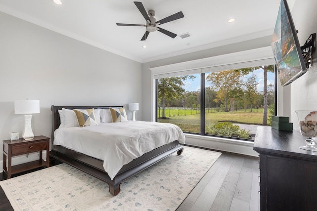 bedroom featuring ornamental molding, ceiling fan, and dark hardwood / wood-style floors