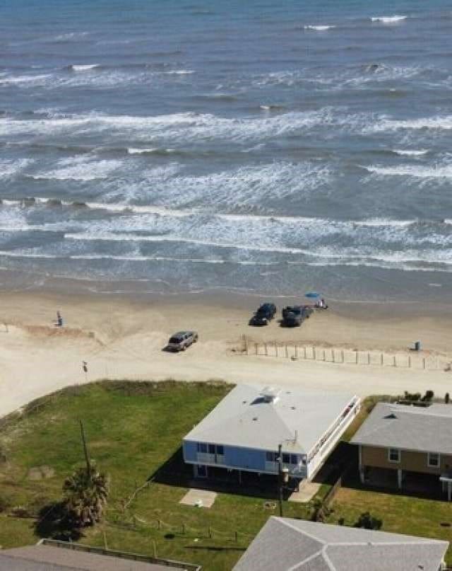 aerial view with a beach view and a water view