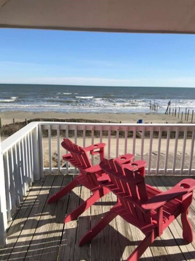 balcony with a view of the beach and a water view