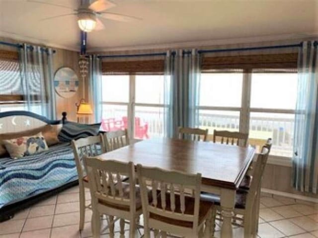 tiled dining space featuring ceiling fan