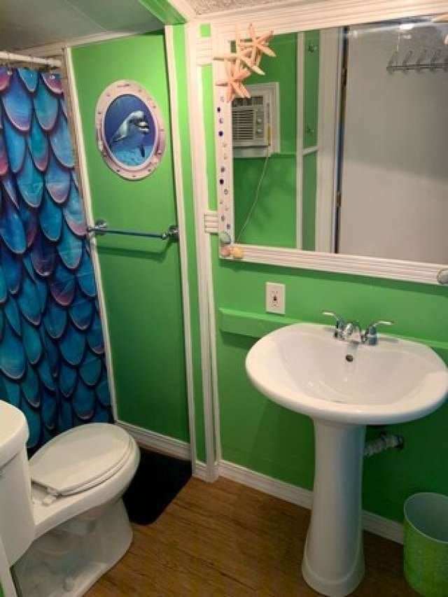 bathroom featuring hardwood / wood-style flooring and toilet