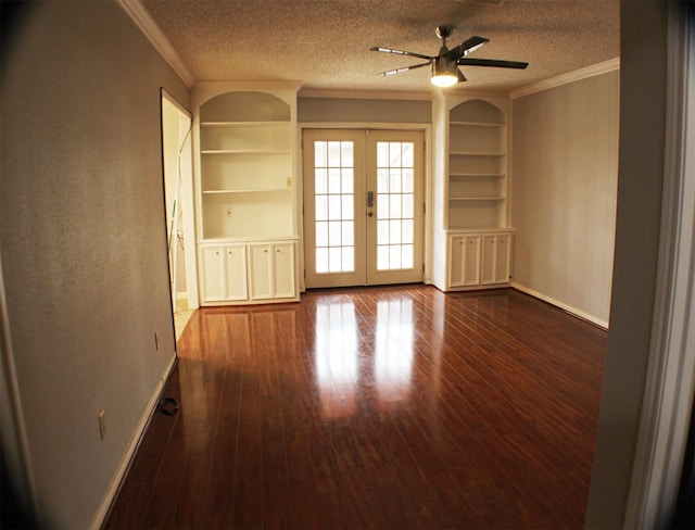 unfurnished room with a textured ceiling, french doors, and dark wood-type flooring