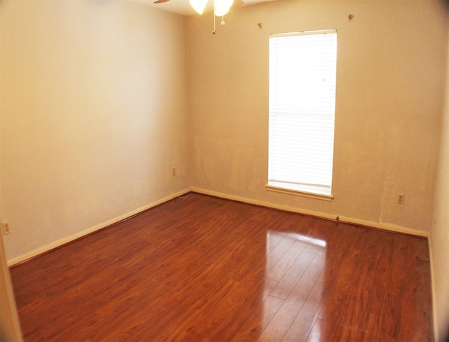 unfurnished room with dark hardwood / wood-style flooring and ceiling fan