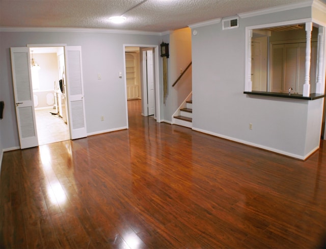 unfurnished room with a textured ceiling, dark wood-type flooring, and ornamental molding