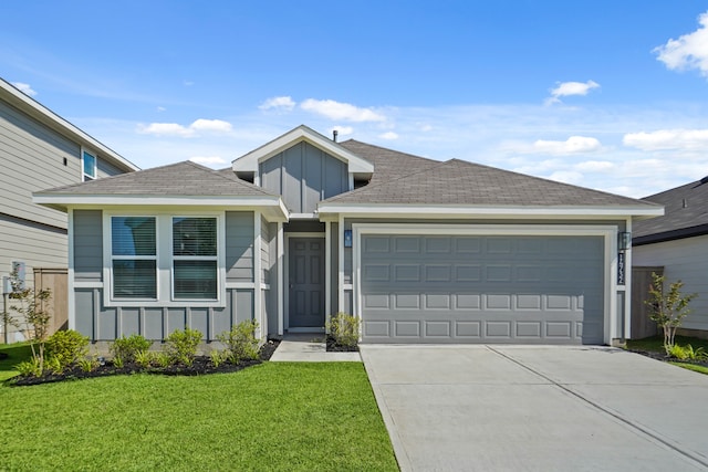 view of front of house with a garage and a front lawn