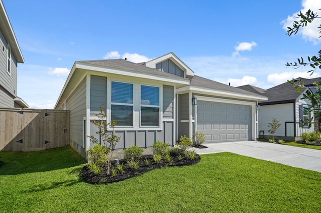 view of front facade with a garage and a front lawn