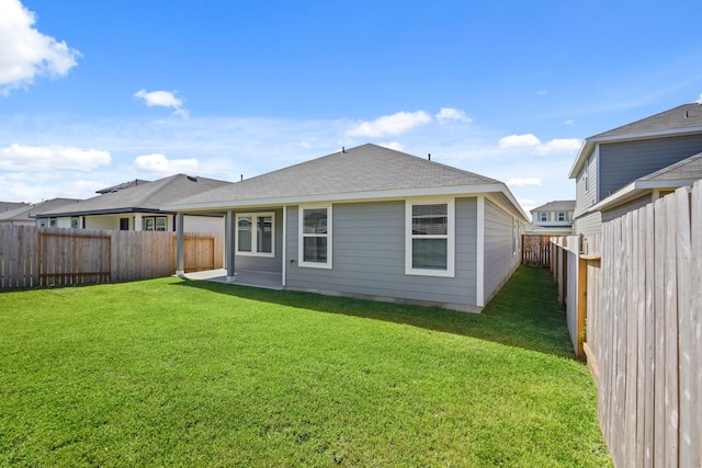 rear view of house with a yard