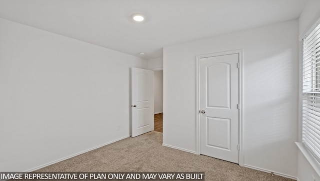 unfurnished bedroom with light carpet