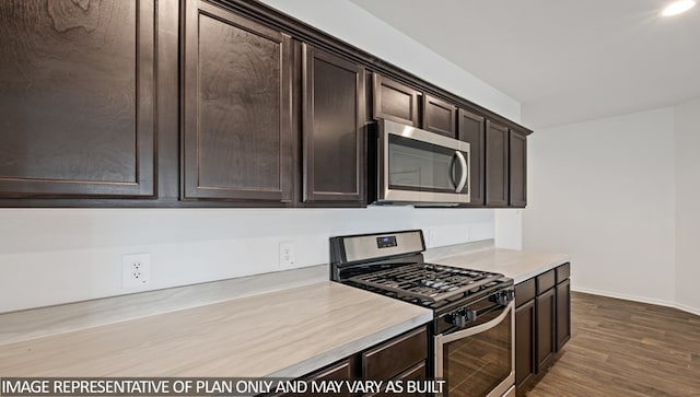 kitchen with dark brown cabinetry, hardwood / wood-style floors, and stainless steel appliances