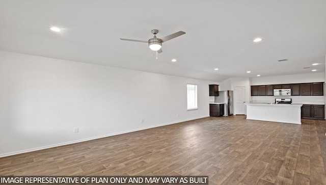 unfurnished living room with ceiling fan and hardwood / wood-style flooring