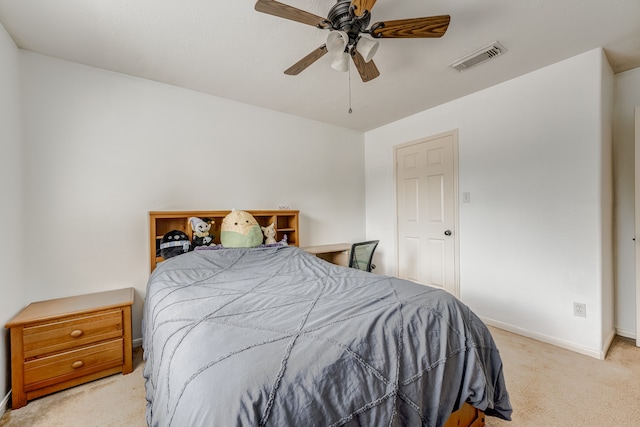 bedroom with ceiling fan and light carpet