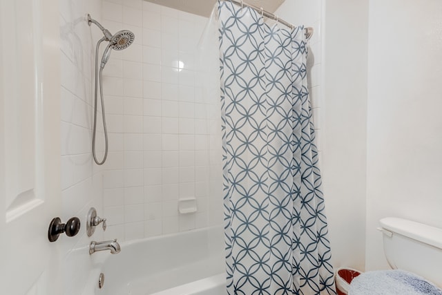 bathroom featuring toilet and shower / bath combo with shower curtain