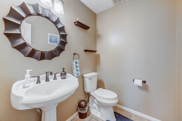 bathroom with sink, tile floors, and toilet