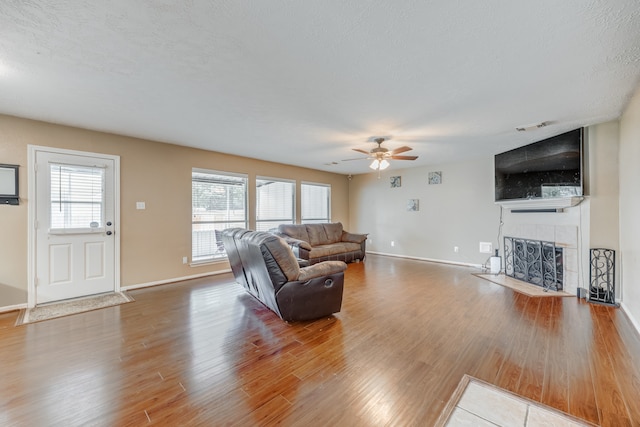 living room with wood-type flooring and ceiling fan