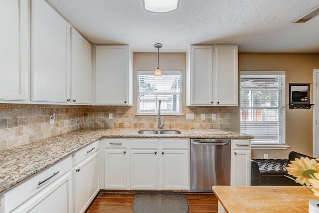 kitchen featuring sink, dark hardwood / wood-style flooring, white cabinetry, and stainless steel dishwasher