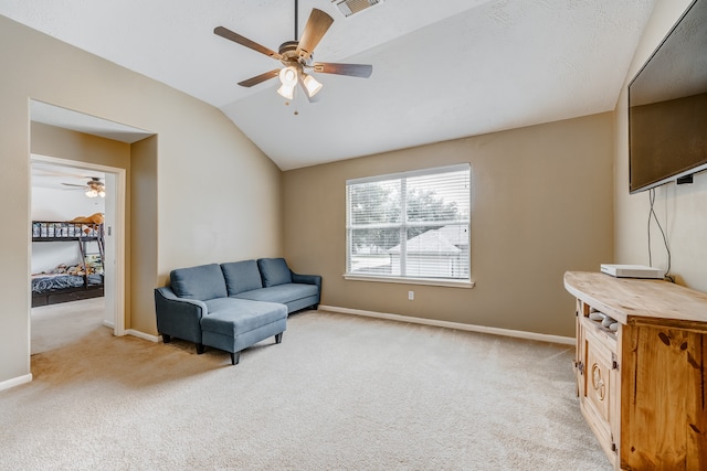 sitting room with lofted ceiling, ceiling fan, and light carpet