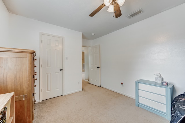 bedroom featuring ceiling fan and light carpet