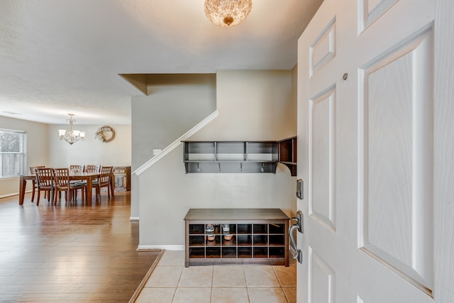 interior space with light hardwood / wood-style floors and a notable chandelier