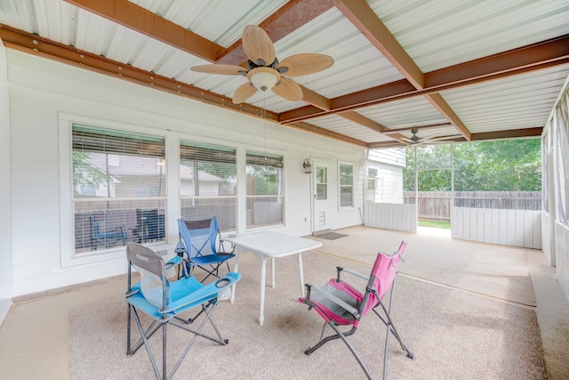 sunroom with beamed ceiling and ceiling fan