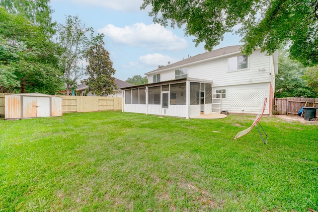 back of property featuring a yard, a storage unit, and a sunroom