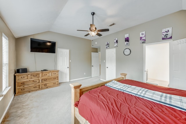 carpeted bedroom with ceiling fan and vaulted ceiling