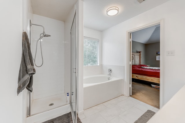 bathroom featuring tile floors and shower with separate bathtub